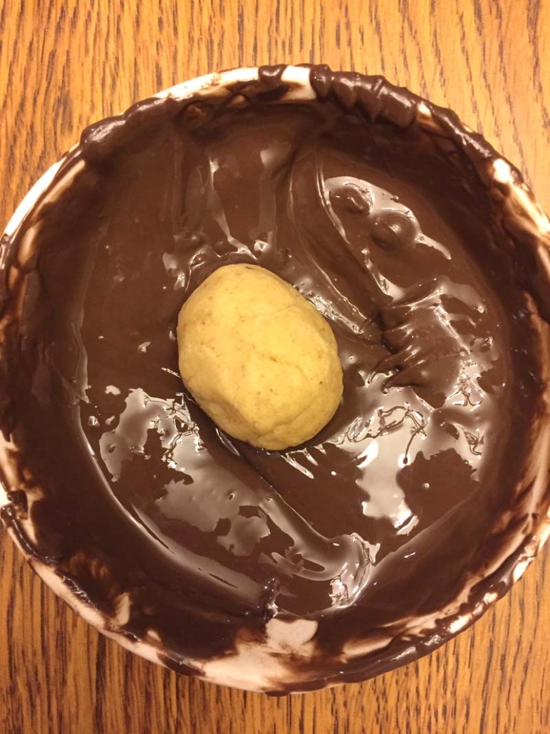 Dipping Cake Ball In Melted Chocolate