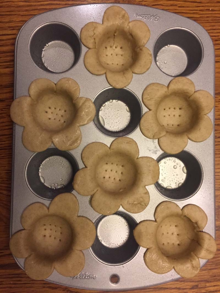 flower shaped dough in a muffin tin