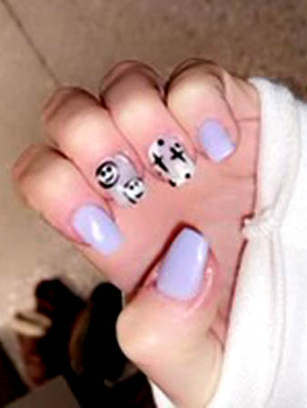 purple nails with smiley happy face and abstract design on two fingers