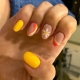 yellow and orange nails designs with flowers and swirls