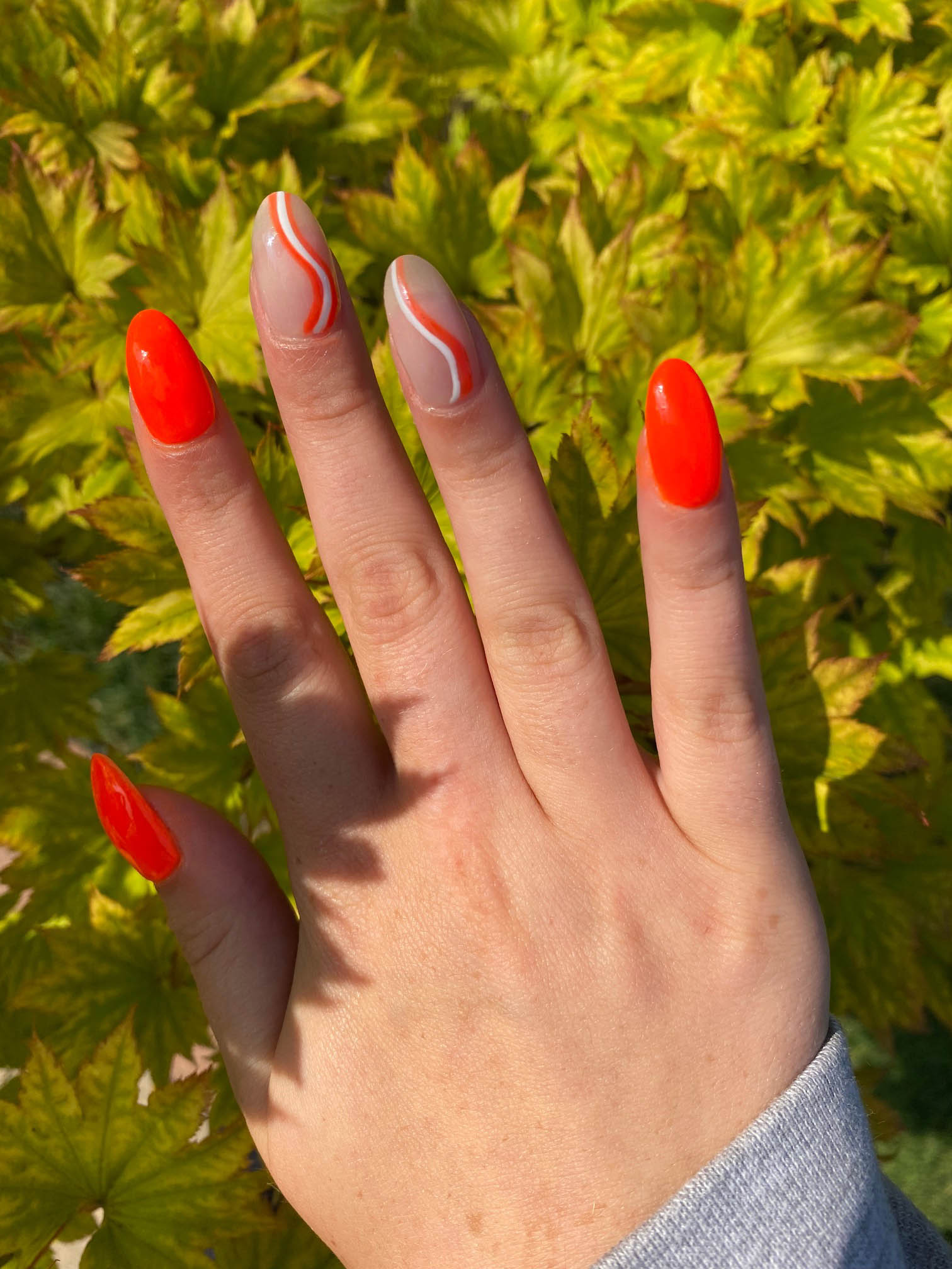 Bright Orange Nails With White Swirls Design DIY Manicure