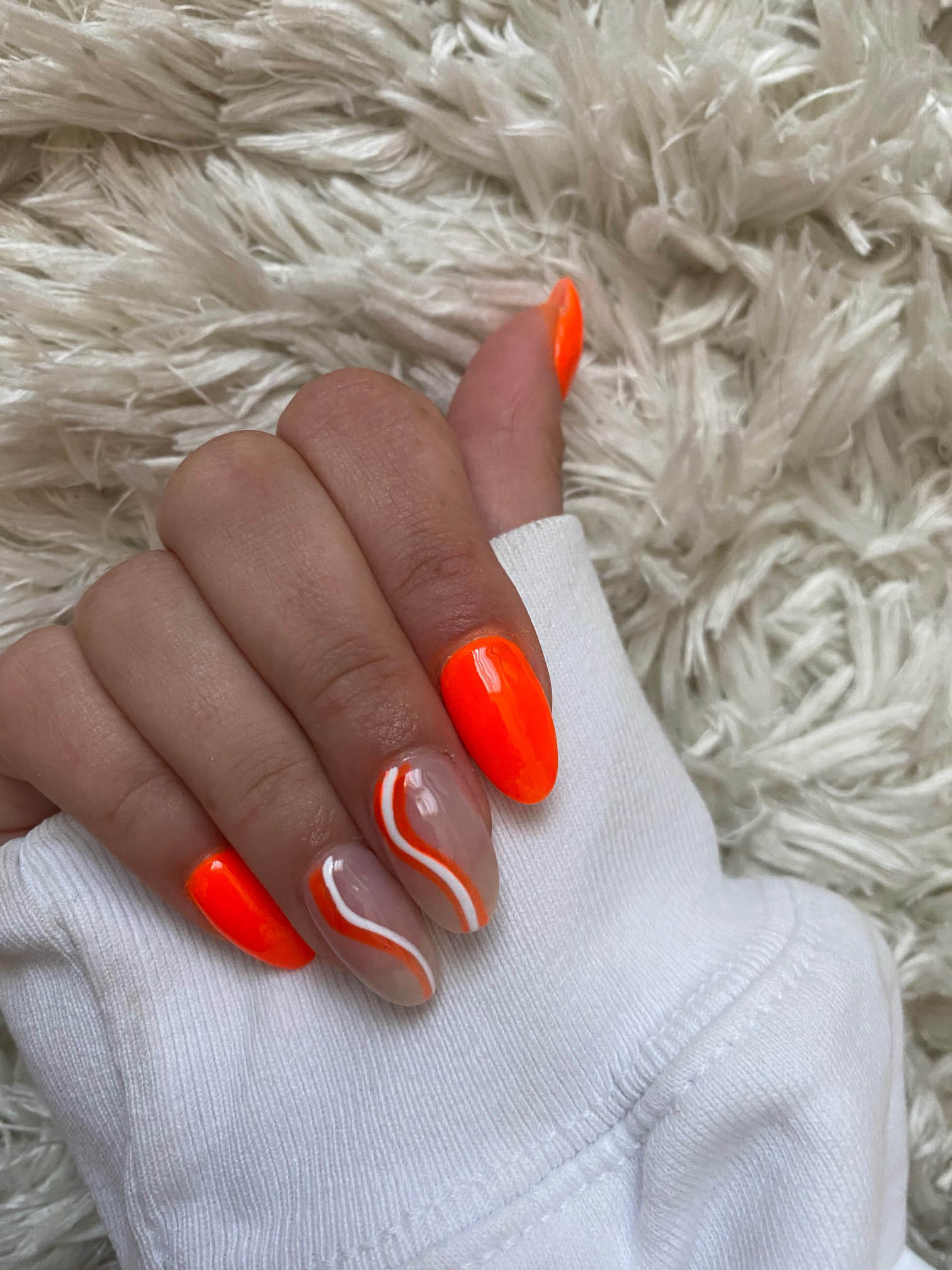 Bold Orange Nails With White Swirls Summer Nail Design
