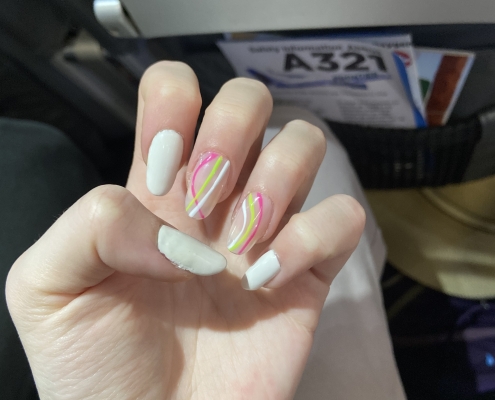 White nails pink green design
