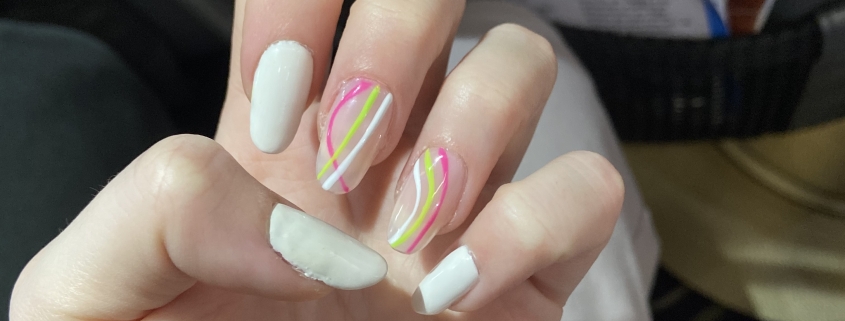 White nails pink green design