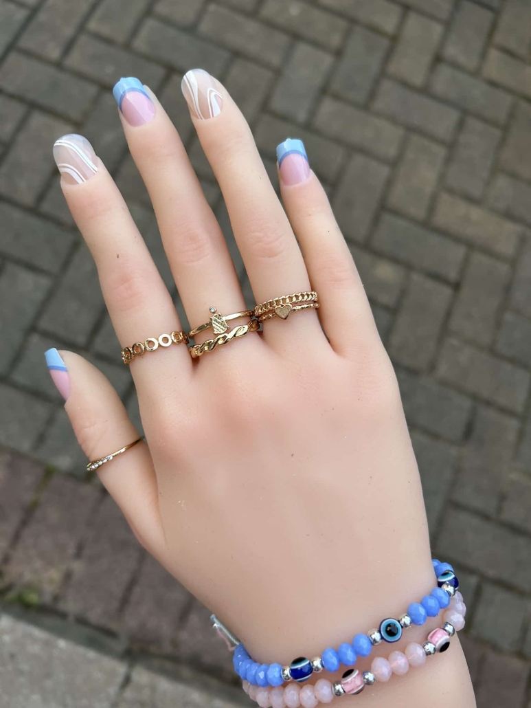 Blue French tip nails with white swirls