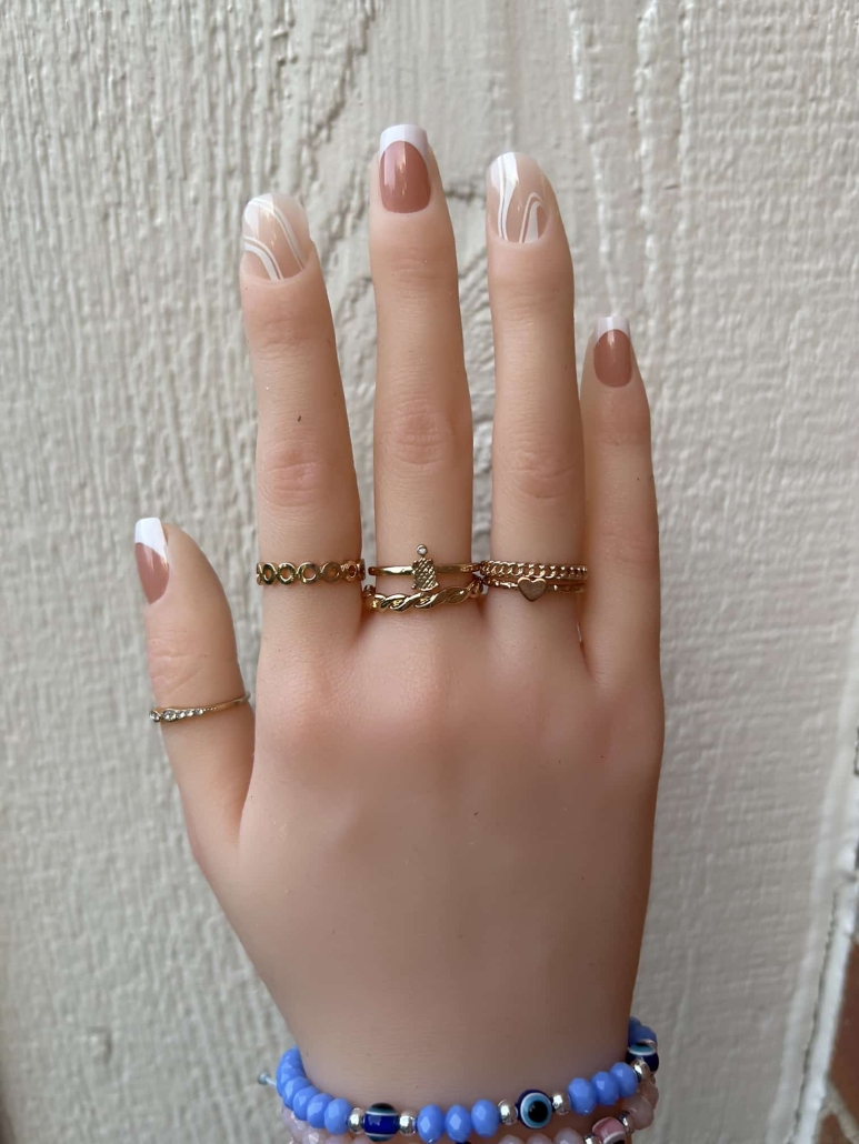 Nude nails with white design